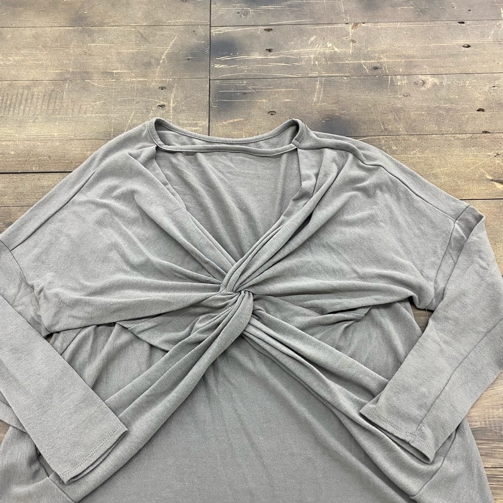 grey sweater with twist in the back